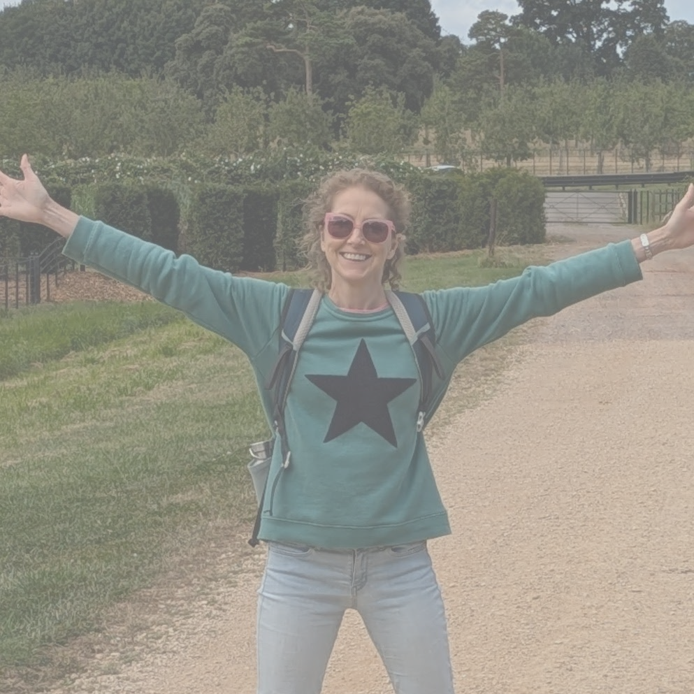 Helen, outside with a backpack on, standing in a star shape.